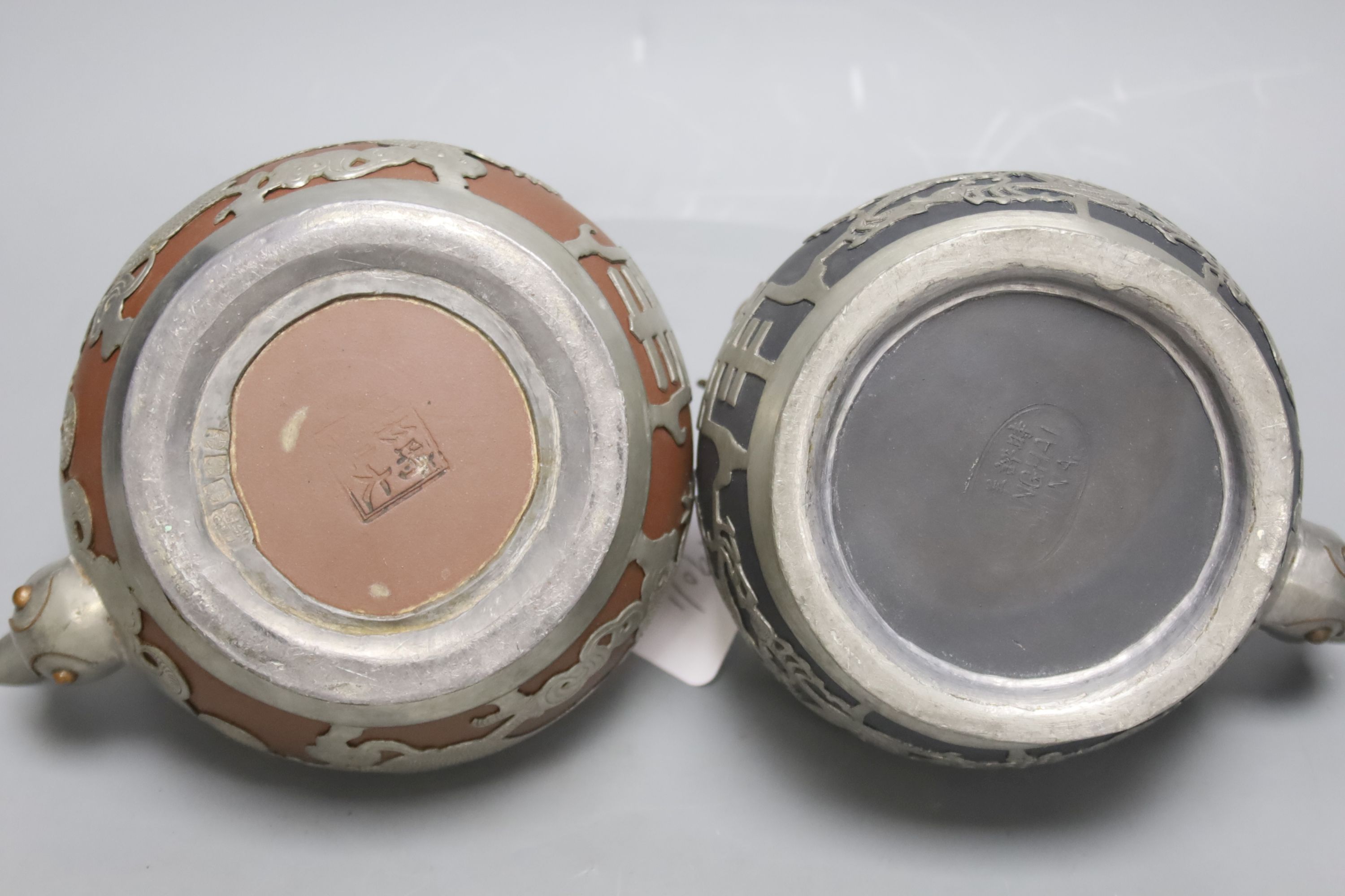 A trio of Chinese pewter mounted Yixing teapots